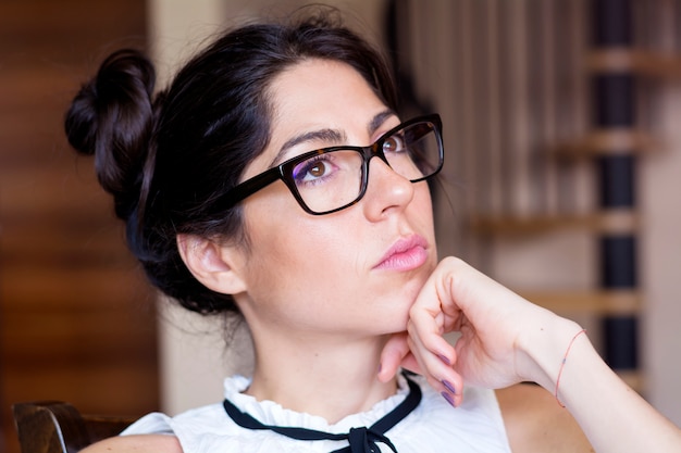 Close-up of girl with hand on her chin