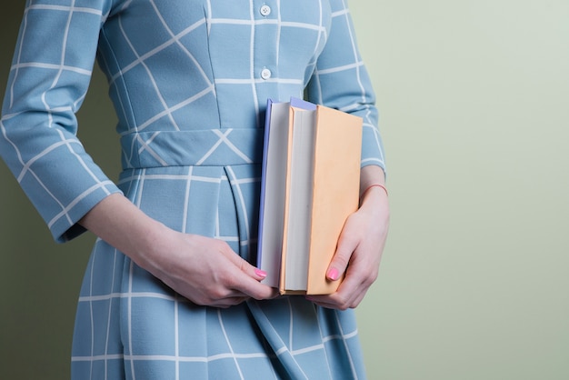 Free Photo close-up of girl with two books