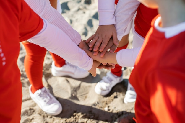 Free Photo close up girls putting hands together