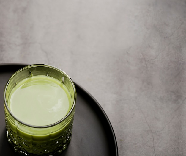 Close-up of glass of matcha tea on plate