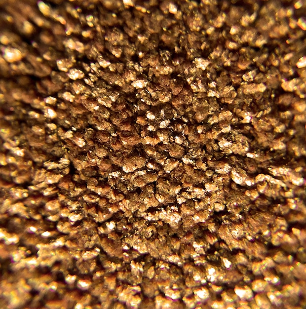 Free photo a close up of a gold piece of material with a circle of gold in the center.