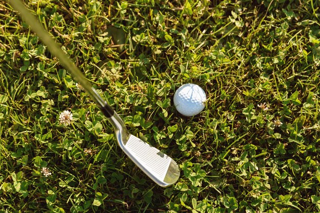 Close-up of golf ball with golf club before tee off