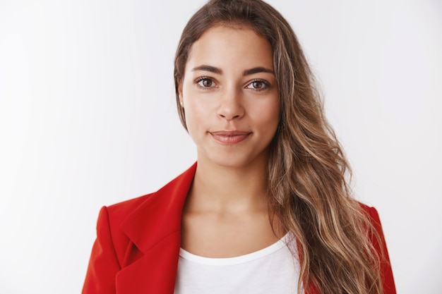 Close-up good-looking smiling friendly female trainee ready tackle assignments smiling broadly feeling lucky day work, self-assured encouraged achieve success, goal, white wall