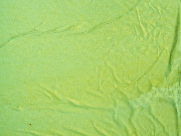 Free photo close-up green crumpled paper background