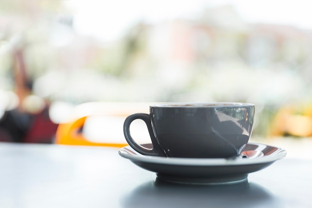 Close-up of grey coffee cup on tabletop