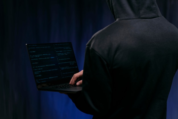 Free Photo close up hacker holding laptop