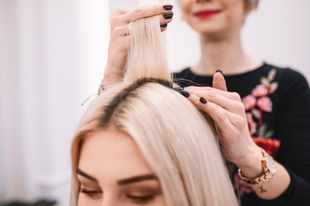 Close-up of hairdresser consulting client