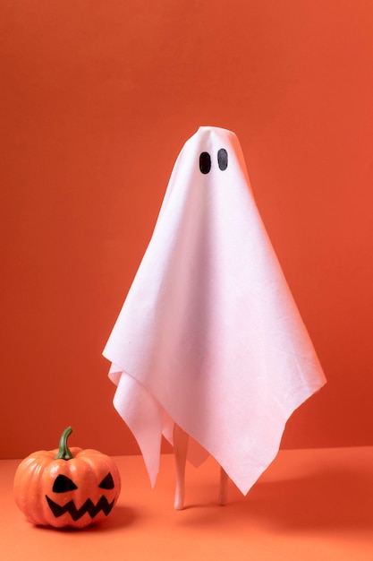 Free photo close-up halloween ghost with pumpkin