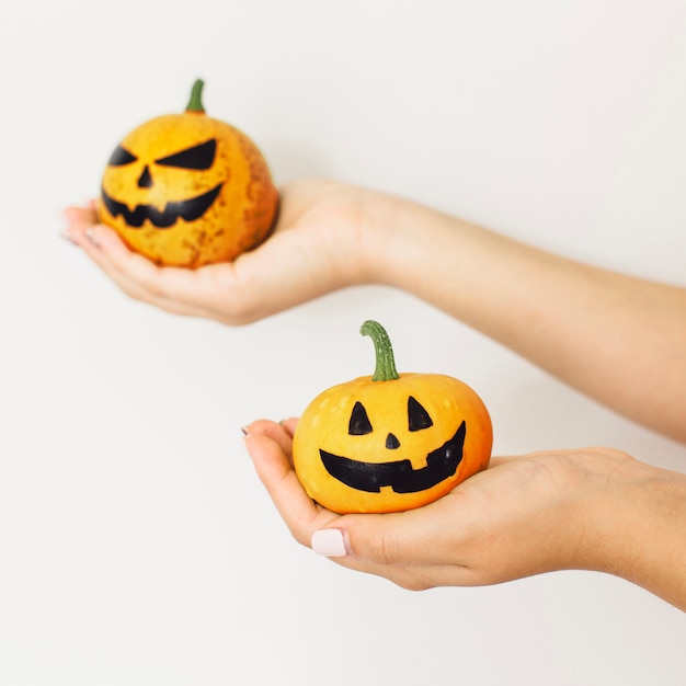 Close-up of Halloween pumpkins in hands