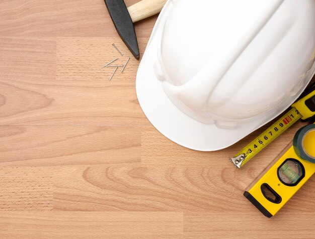 Close-up hammer and nails on wooden background