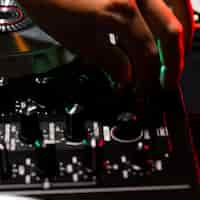 Free photo close-up hand adjusting dj console