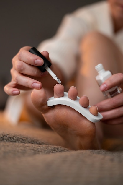 Close up hand applying nail polish