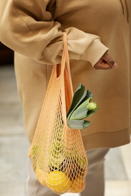 Free Photo close up hand carrying eco bag