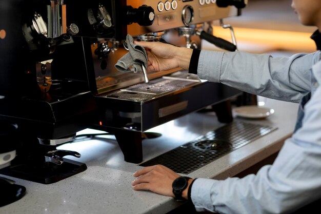 Close up hand cleaning coffee machine