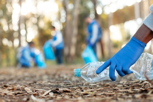 Close up hand collecting bottle