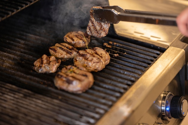 Free photo close-up hand cooking meat