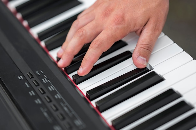 Free photo close-up hand on digital piano high view