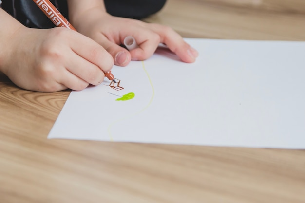 Close-up of hand drawing on a blank paper