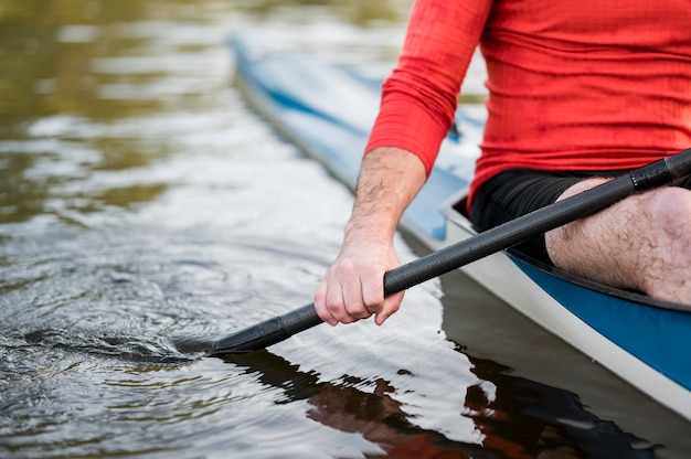 Close-up hand holding black oar