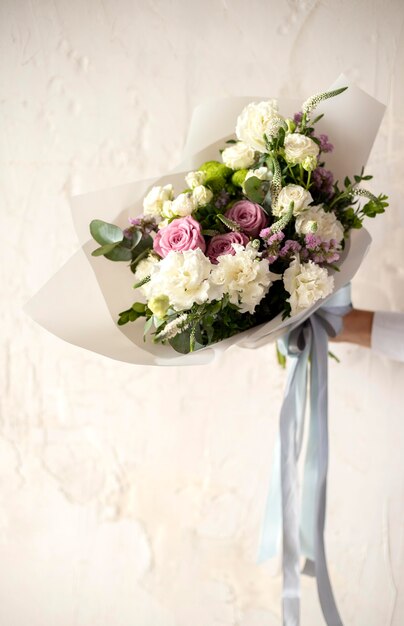 Close up hand holding bouquet