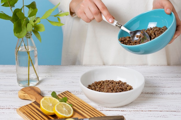 Close up hand holding bowl with lentils