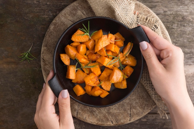 Close-up hand holding bowl with potatoes