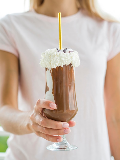 Free Photo close-up hand holding chocolate milkshake