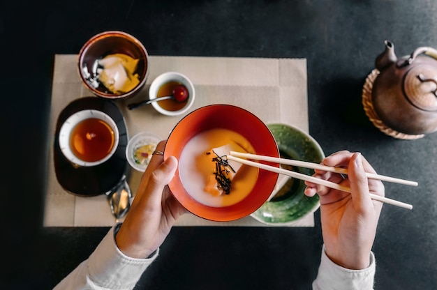 Free Photo close up hand holding chopsticks