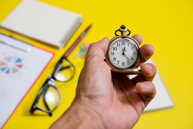 Free photo close up hand holding clock