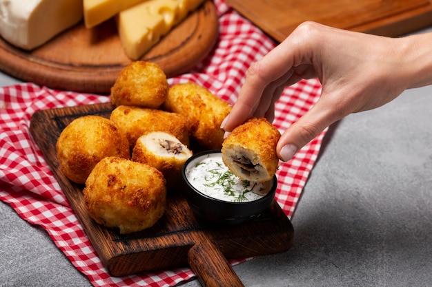 Close up hand holding food croquette