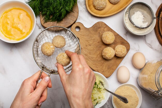 Close up hand holding food croquette