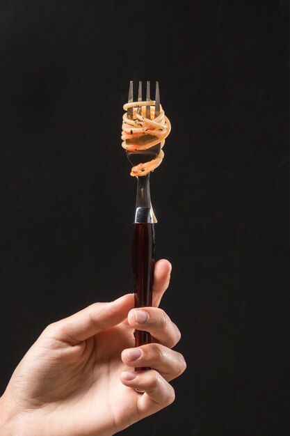 Close-up hand holding fork