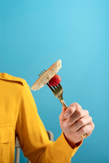 Close up hand holding fork