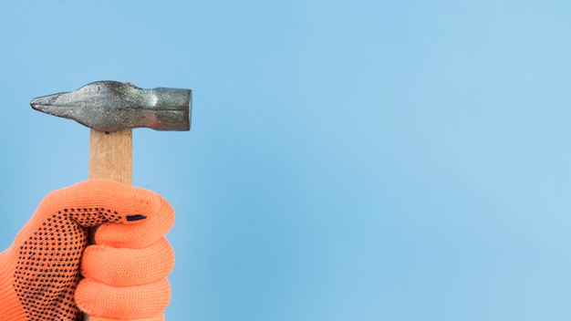 Free Photo close-up hand holding hammer