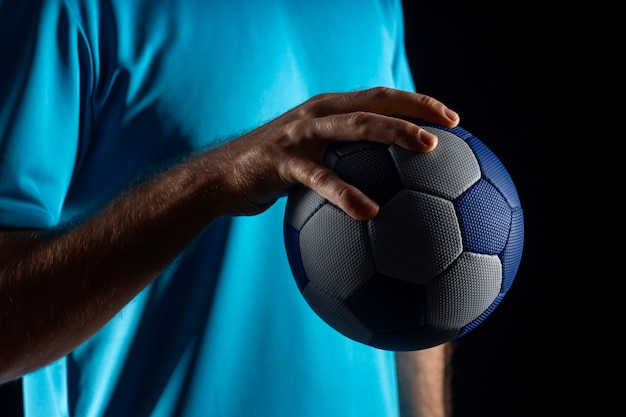 Close up on hand holding handball ball