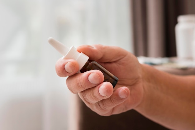 Close-up hand holding nasal spray