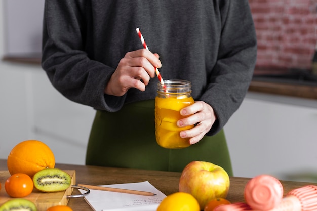 Free photo close up hand holding natural juice