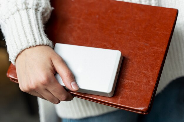 Close up hand holding notebook and ssd