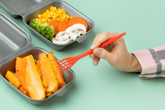 Close up hand holding orange fork