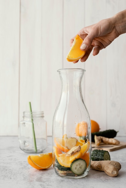 Free photo close-up hand holding orange slice