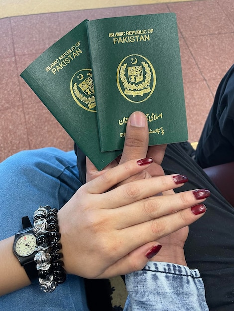 Free Photo close up hand holding pakistan passport isolated on white background