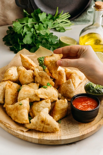 Free photo close-up hand holding pakistani food