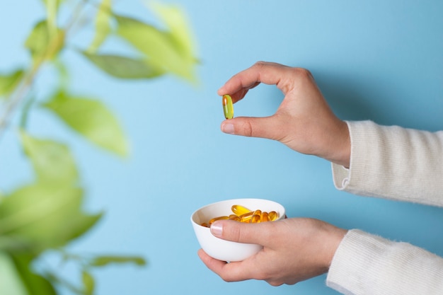 Free Photo close up hand holding pills bowl