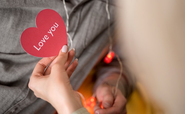 Free photo close up hand holding pink heart