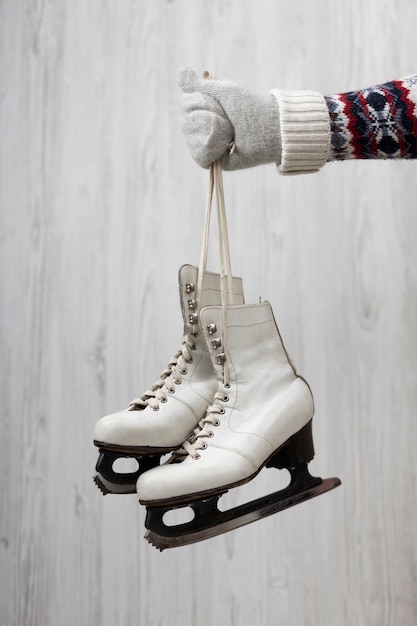 Free Photo close up hand holding skates