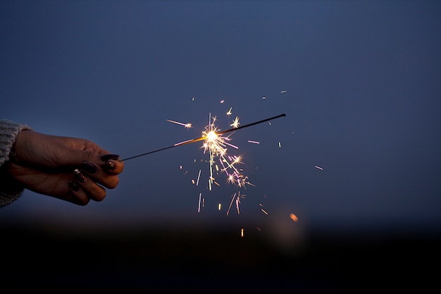 Close up hand holding sparks