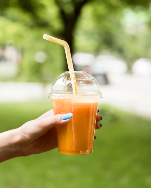 Close-up hand holding tasty smoothie