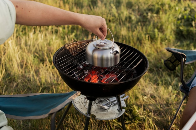 Free photo close up hand holding teapot