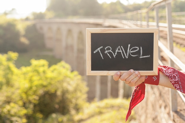 Free Photo close-up hand holding travel board