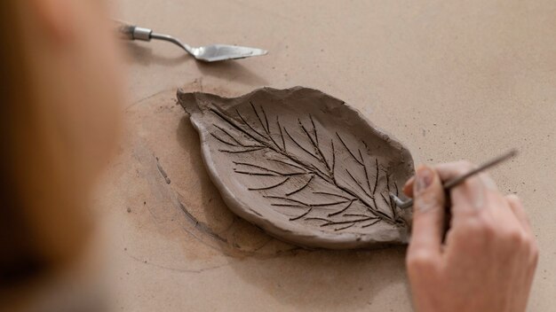 Close-up hand making leaf